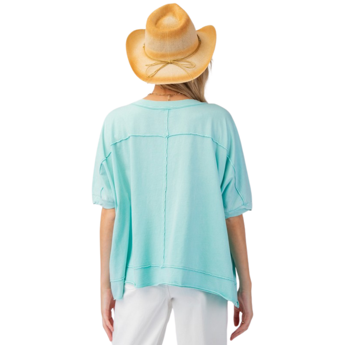 This Mineral Washed Jersey Knit Top by Easel is a must-have for any wardrobe. The beautiful turquoise blue color adds a pop of color while the drop shoulder and short sleeves provide a comfortable fit. Complete with a pocket, this top is both stylish and functional.