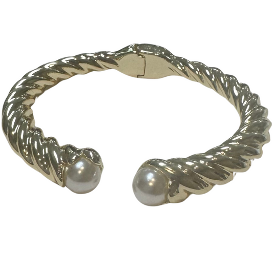 This open cuff bangle bracelet features a sophisticated twisted design in gleaming gold, accented with a delicate pearl for an elegant touch. Its open structure allows for easy adjustment and comfortable wear, making it a versatile addition to any jewelry collection. Perfect for elevating both casual and formal looks with expert craftsmanship and timeless style.