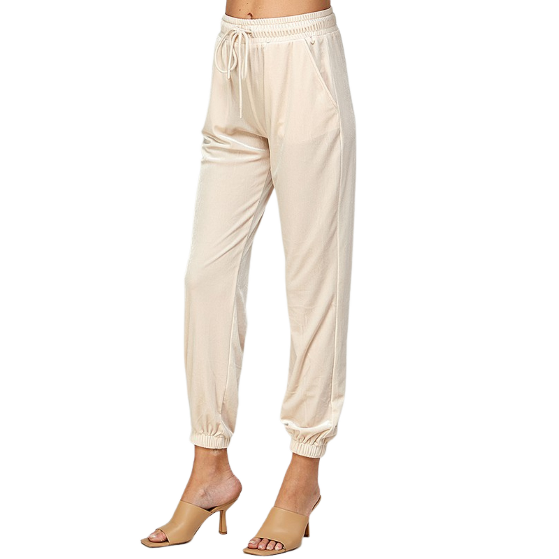 Feel comfortable while making a statement in our Velvet Joggers. These pants feature a cream color and a velvet feel for a truly luxurious look. They are the perfect choice for any occasion.