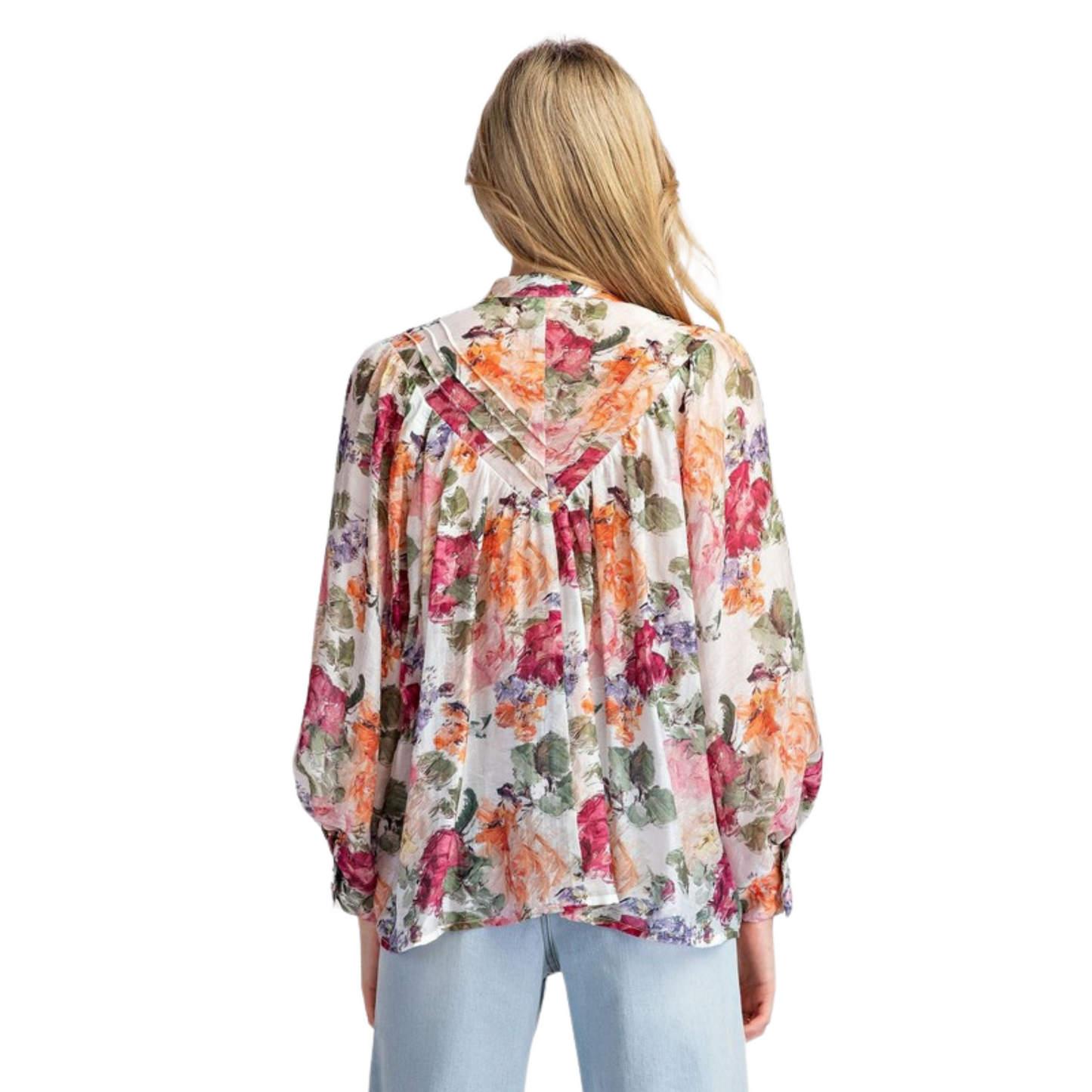 This vintage floral printed blouse is a timeless addition to any wardrobe. The rounded neckline, button down front, and added pleats create a flattering and relaxed silhouette. With buttoned cuffs and a slightly bubbled sleeve effect, this blouse exudes both elegance and comfort.