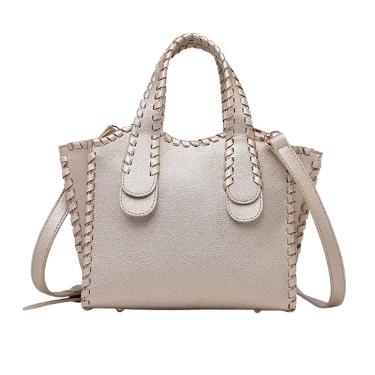 The Marla Whipstitch Shaped Satchel by Jen &amp; Co. is a refined small purse crafted in a striking gold tone. Its distinctive whipstitch detailing adds a sophisticated texture, making it an elegant accessory for both day and evening wear. Compact yet functional, this satchel offers a stylish solution for carrying essentials with expert craftsmanship and timeless design.
