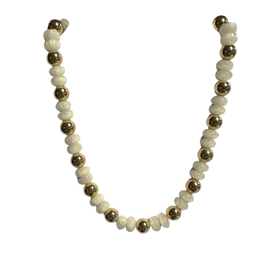 Elevate your everyday style with this refined short beaded necklace from Perdido Gems. Crafted with lustrous white and gold beads, this piece strikes the perfect balance between sophistication and versatility. The compact length makes it ideal for layering or wearing solo, complementing both casual and formal ensembles. Each bead is carefully selected to ensure quality and lasting brilliance. A timeless accessory that transitions seamlessly from day to evening wear.
