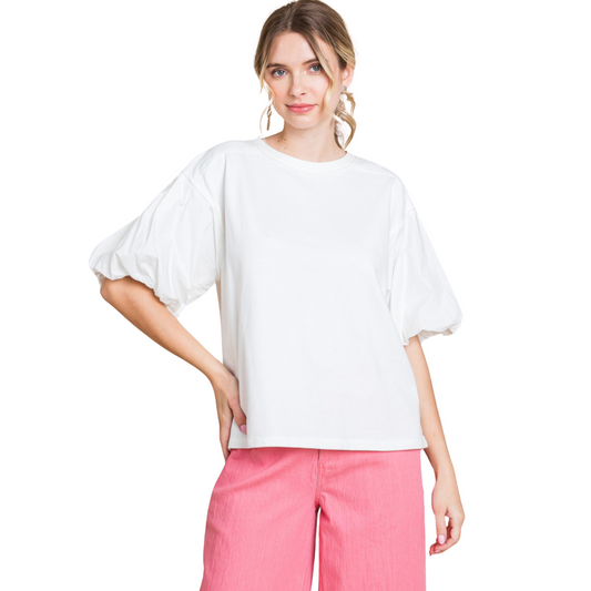 This off-white top features mixed fabric, a U-neck, 1/2 balloon sleeves, and raw edge details for a unique look. The lightweight and non-sheer materials provide comfort and versatility. Perfect for a casual or dressed up style.