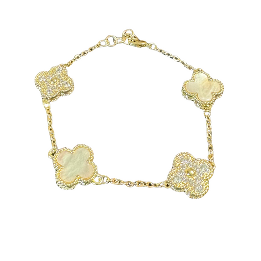 This elegant bracelet features alternating white and rhinestone clovers, showcasing a stunning gold finish. Adding a touch of glamour and sophistication to any outfit, this bracelet is a must-have accessory for any fashion-forward individual. The perfect blend of classic and contemporary styles, this bracelet is sure to become a staple piece in your jewelry collection.
