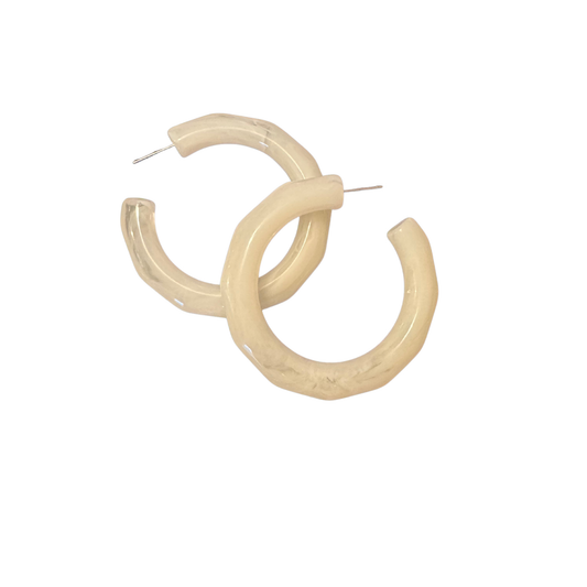 Make a bold statement with these striking white acrylic hoop earrings from our Euro Collection. Lightweight yet impactful, these large hoops deliver timeless elegance with a contemporary edge. The smooth acrylic construction ensures comfortable all-day wear, while the generous size commands attention without sacrificing wearability. Perfect for elevating casual outfits or adding dimension to evening looks, these versatile earrings are a sophisticated essential for any jewelry wardrobe.