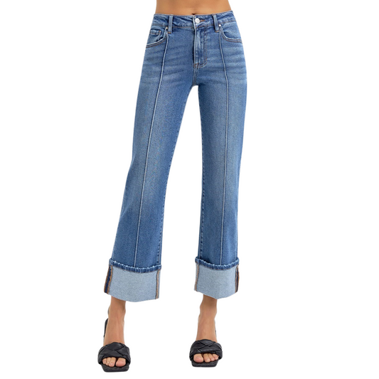 These High Rise Straight Wide Cuff Jeans from Risen offer a flattering medium wash and a wide cuff hem that adds a stylish touch at ankle length. Designed for a comfortable fit, they balance classic straight-leg tailoring with contemporary detailing, making them versatile for both casual and polished looks. The high-rise waist enhances posture and elongates the legs for a confident silhouette.