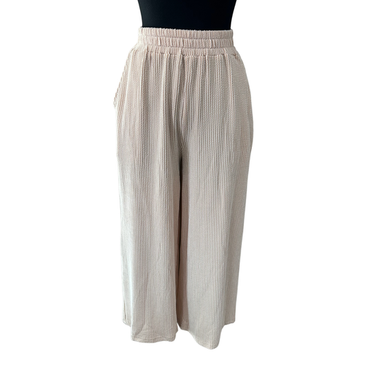 Elevate your casual wardrobe with these Wide Leg Capri Pants from She+Sky. Crafted from a textured knit fabric, they offer a comfortable, breathable fit perfect for warm weather styling. The standout feature? Functional knit pockets that blend seamlessly into the design, giving you practical storage without compromising the silhouette. The relaxed wide-leg cut provides an effortless, flattering look that works from weekend errands to laid-back social outings. 