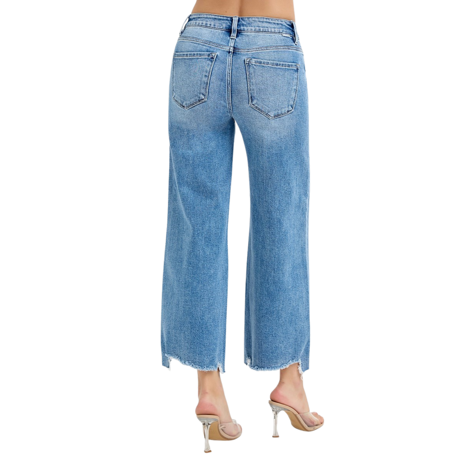 These Risen brand cropped wide-leg jeans feature a high-rise fit and a versatile medium wash, offering a modern silhouette that balances comfort and style. The wide leg design allows for ease of movement and pairs effortlessly with various tops, while the cropped length adds a contemporary touch ideal for showcasing footwear. Perfect for creating polished, everyday looks with expert-level fashion appeal.