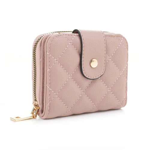 The Lucy Quilted Wallet is a stylish accessory that comes in three colors - beige, stone and blush - each featuring a unique quilted design and gold button closure. Crafted with care and attention to detail, this wallet offers a classic look with modern flair.