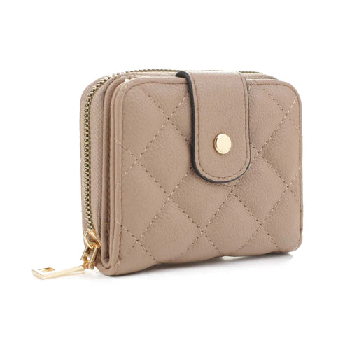 The Lucy Quilted Wallet is a stylish accessory that comes in three colors - beige, stone and blush - each featuring a unique quilted design and gold button closure. Crafted with care and attention to detail, this wallet offers a classic look with modern flair.